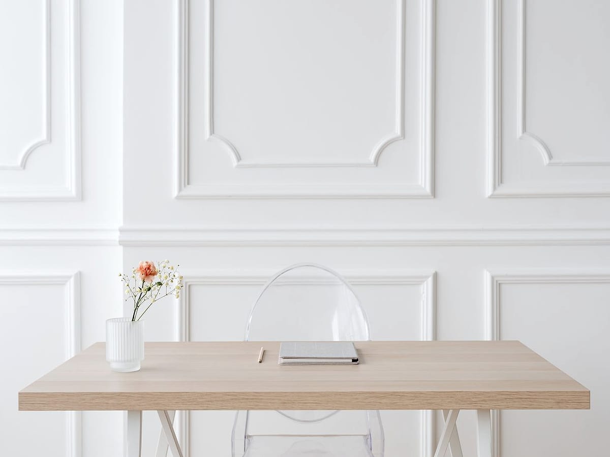 A calm, uncluttered desk in a light filled office